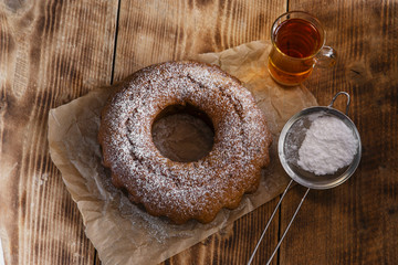 freshly baked ring  cake with icing sugar