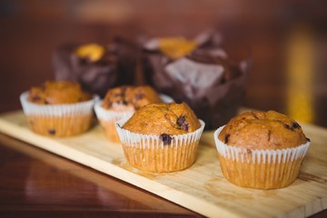 Chocolate chip muffins on cutting board