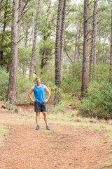 Young happy jogger standing