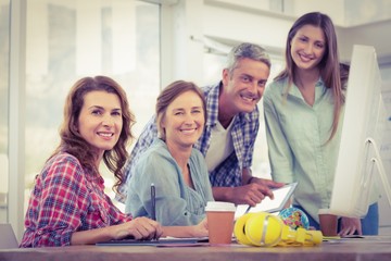 Casual business team having a meeting using a computer