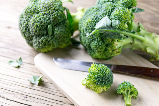 fresh broccoli on a cutting board and knife