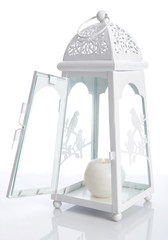 White metal lantern with candle