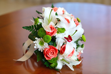 Wedding bouquet of roses and lilies for bride at a wedding party