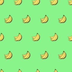 Seamless pattern with bananas on green background
