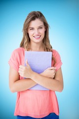 Composite image of pretty hipster holding notepad