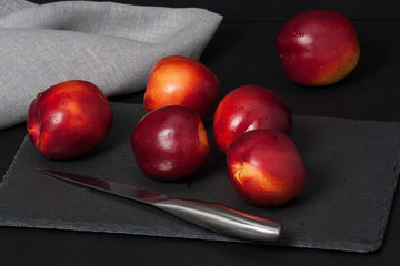 Fresh Nectarine Fruits On Slate Stone. Natural Linen Napkin