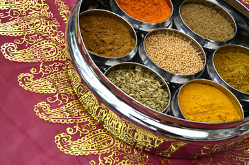 Indian Cuisine Cookery Spices in Silver Pots on Pink and Gold Saree