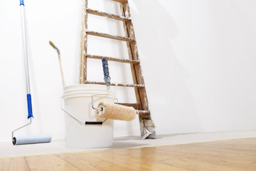 painter wall concept, ladder, bucket, roll paint on the floor