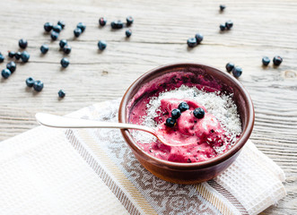 banana ice cream with blueberries and coconut flakes