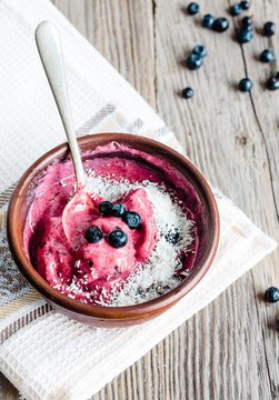 banana ice cream with blueberries and coconut flakes
