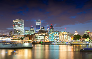 Fototapeta na wymiar Night lights of London. Buildings reflections near river Thames