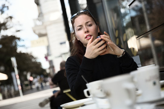 Young lady sitting in sidewalk café, Vienna