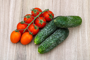 Cucumbers and tomatoes on the branch