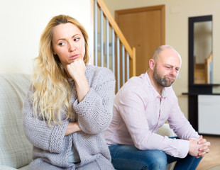 Sad woman and man after quarrel