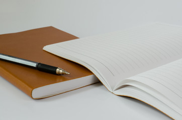 Notebook Open and Pen On White Background.