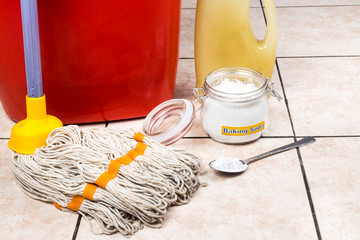 Baking soda with pail, mop, detergent for house cleaning.