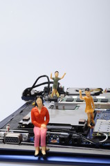 Disassembled computer components and people  figurines