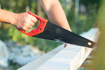 male worker sawing a board