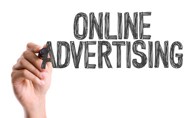 Hand with marker writing the word Online Advertising