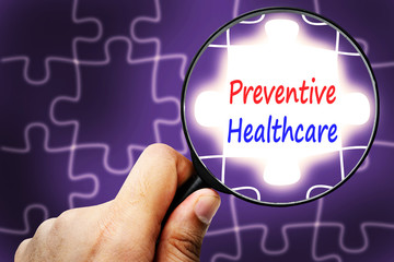 preventive health care word. Magnifier and puzzles.