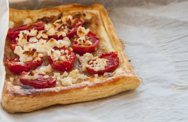 Tomato tart, puff pastry topped with mustard, cheese and cherry toamtoes.