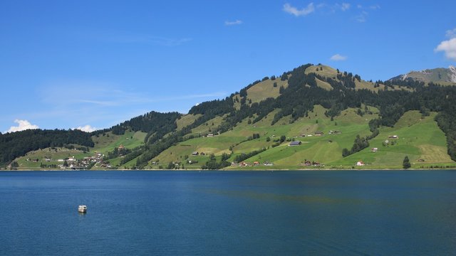 Blue water of lake Waegitall and village Innerthal