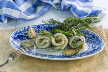Pickled rollmops herrings with dill