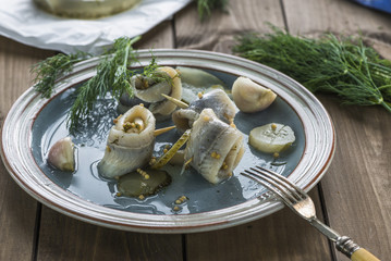 Pickled rollmops herrings with dill
