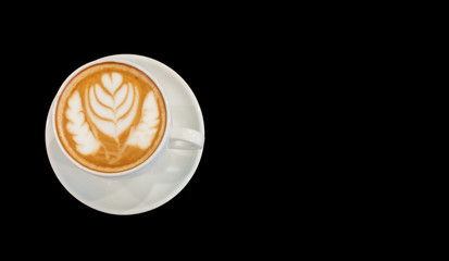Hot cafe latte wirh latte art on black background