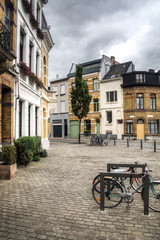 A street scene with typical houses and some bicycles in the town of Berchem in Antwerp, Belgium
