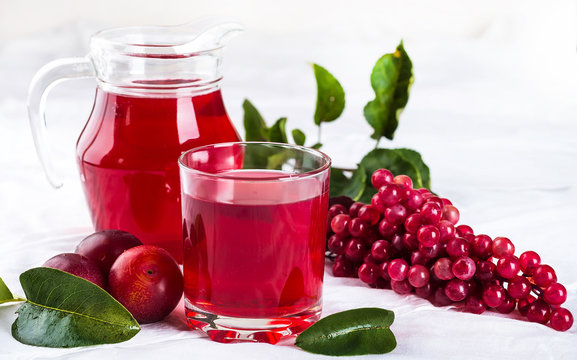 Compote of fresh fruit, background of green leaves
