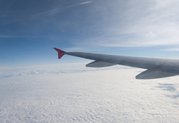 view from the plane on the wing and clouds