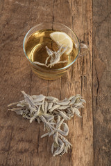 sage tea and sage leafs on wooden table
