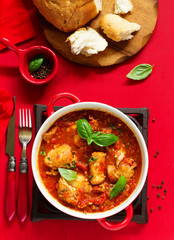 Baked rabbit in tomato sauce with rosemary and basil. Italian Cuisine.