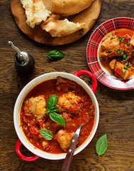 Baked rabbit in tomato sauce with rosemary and basil. Italian Cuisine.