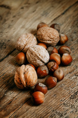 Hazelnuts and walnuts on an old wooden table, selective fokuks