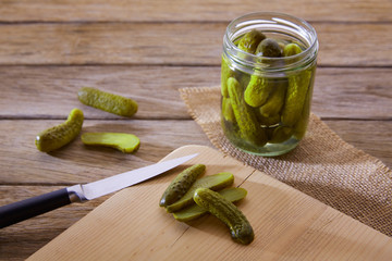 bottled pickles cucumbers in wooden table