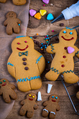 Fototapeta na wymiar Decorating homemade gingerbread man for Christmas