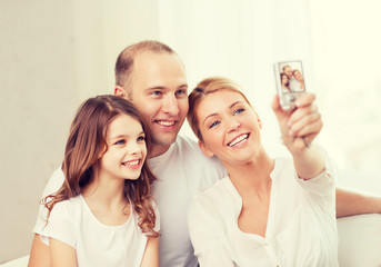 happy family with little girl making self portrait