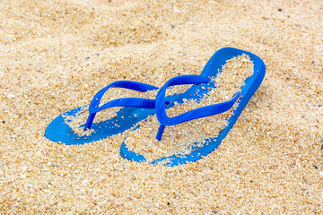 Beach slippers on sand