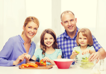 Obraz na płótnie Canvas happy family with two kids making dinner at home