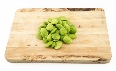 Parkia speciosa seed on wooden cutting board isolated on white background