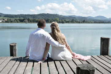 A couple on the wooden jetty at the lake. Switzerland