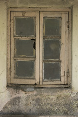 Old cracked wall with a window