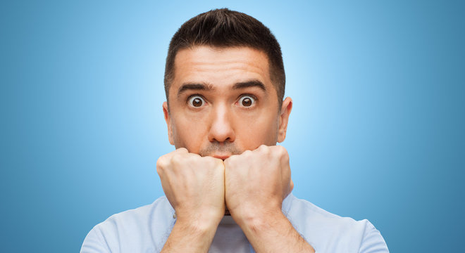 scared man face over blue background