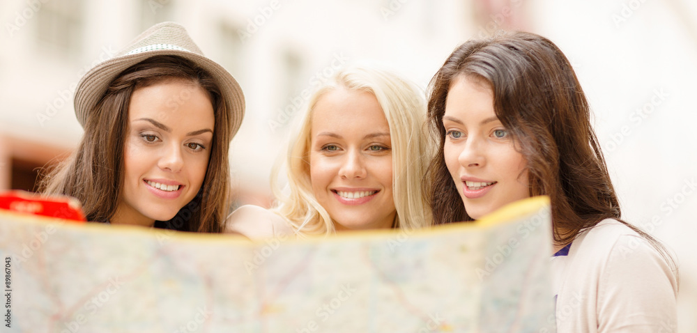 Poster beautiful girls looking into tourist map in city