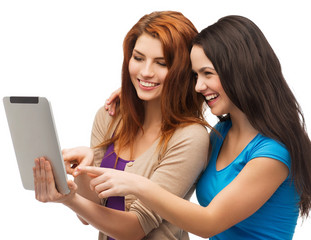 two smiling teenagers with tablet pc computer