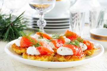 Appetizer of hash browns and red fish.