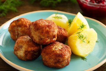 Hot meatballs with boiled potatoes and cranberry sauce ..