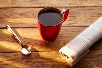 Coffee red cup newspaper morning breakfast on wood